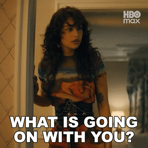 A Woman Standing In A Doorway With The Words " What Is Going On With You " Above Her GIF