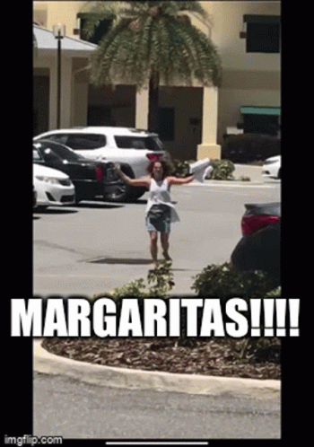 A Woman Standing In A Parking Lot With The Words Margaritas Written On It GIF