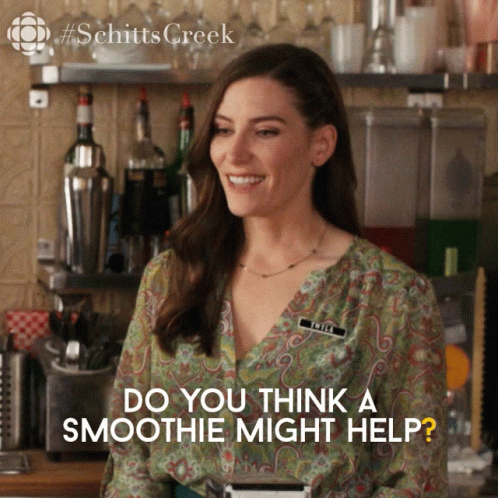 A Woman Standing In Front Of A Bar With The Words Do You Think A Smoothie Might Help Below Her GIF