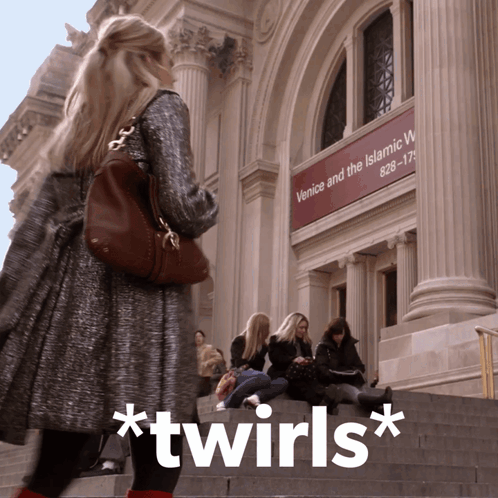A Woman Standing In Front Of A Building That Says Venice And The Islamic World On It GIF