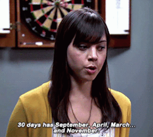 A Woman Standing In Front Of A Dart Board Says 30 Days Has September April March And November GIF