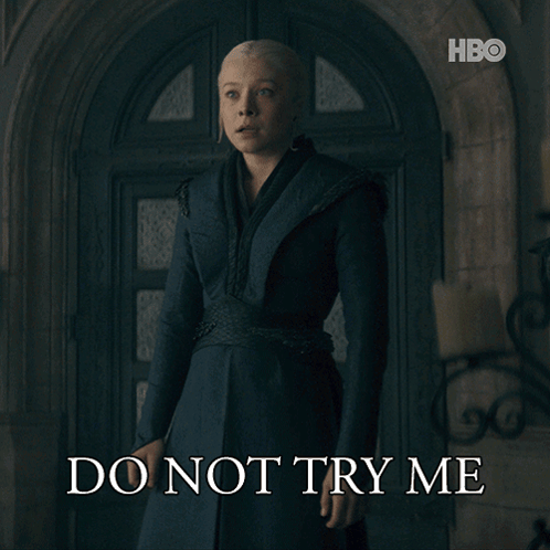 A Woman Standing In Front Of A Door With The Words Do Not Try Me On The Bottom GIF