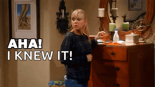 A Woman Standing In Front Of A Dresser With Aha I Knew It Written Above Her GIF