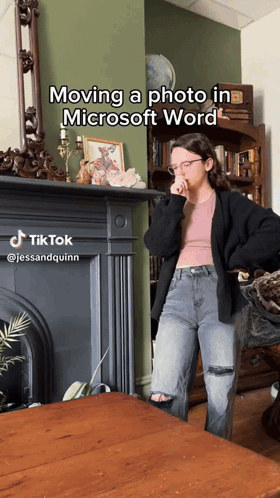 A Woman Standing In Front Of A Fireplace With The Caption Moving A Photo In Microsoft Word On It GIF