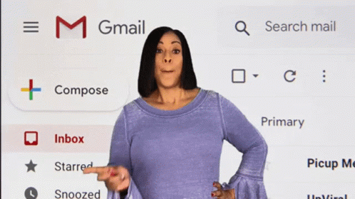 A Woman Standing In Front Of A Gmail Screen GIF