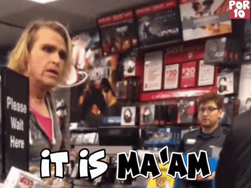 A Woman Standing In Front Of A Sign That Says It Is Ma Am GIF