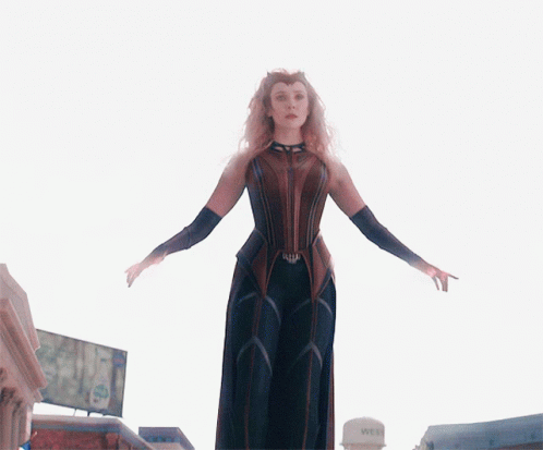 A Woman Standing In Front Of A Water Tower That Says Wet On It GIF