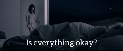 a woman standing next to a bed with the words " is everything okay " on the bottom
