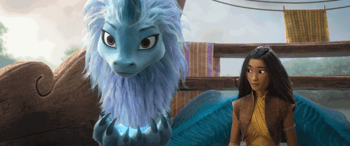 A Woman Standing Next To A Blue Dragon With A Unicorn Horn GIF