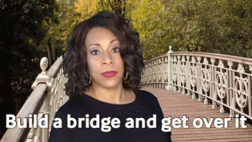 A Woman Standing On A Bridge With The Words " Build A Bridge And Get Over It " GIF