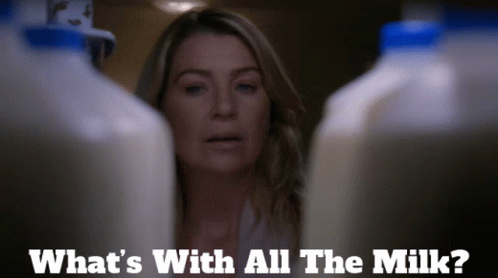A Woman Stands Between Two Bottles Of Milk And Says What 'S With All The Milk ? GIF