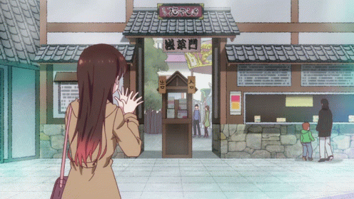 A Woman Stands In Front Of A Building With A Sign That Says " Entrance " GIF