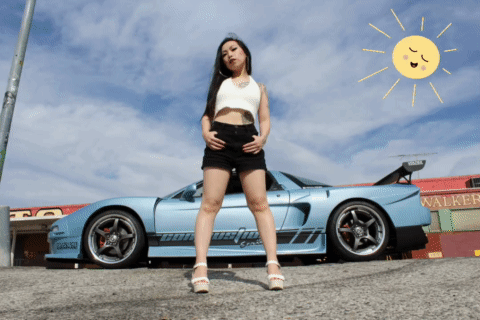 A Woman Stands In Front Of A Car That Says Walker GIF