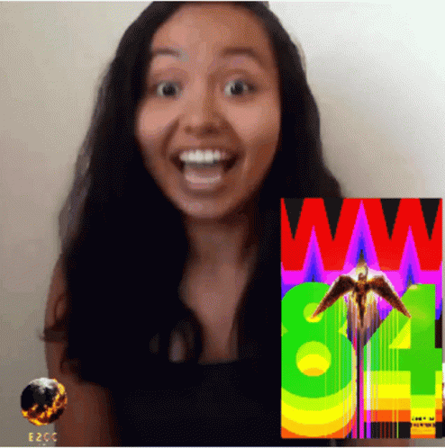 A Woman Stands In Front Of A Colorful Poster That Says Ww GIF