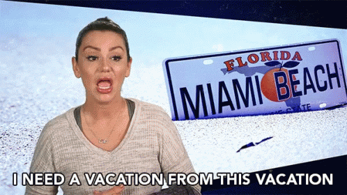 A Woman Stands In Front Of A Florida Miami Beach License Plate GIF