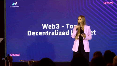 A Woman Stands In Front Of A Large Screen That Says Web3 Tor Decentralized GIF