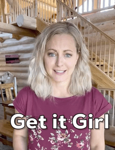 A Woman Stands In Front Of A Log Cabin With The Words Get It Girl Written On Her Shirt GIF