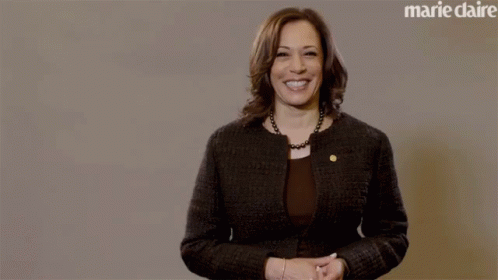 A Woman Stands In Front Of A Marie Claire Ad GIF