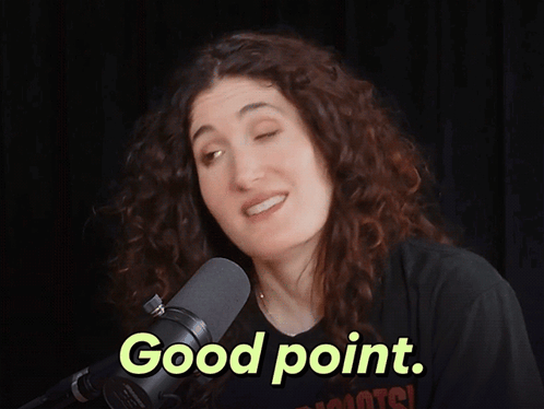 A Woman Stands In Front Of A Microphone With The Words Good Point Above Her GIF