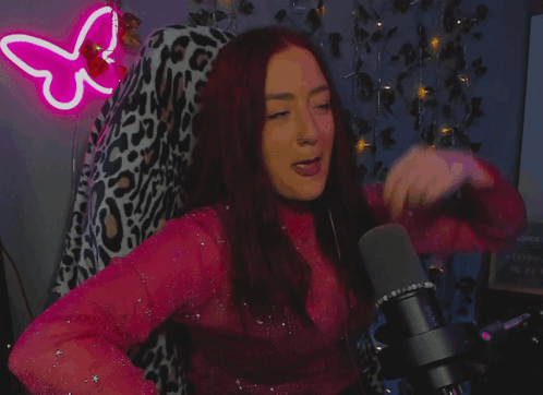 A Woman Stands In Front Of A Microphone With The Words " Mic Drop " On The Bottom GIF