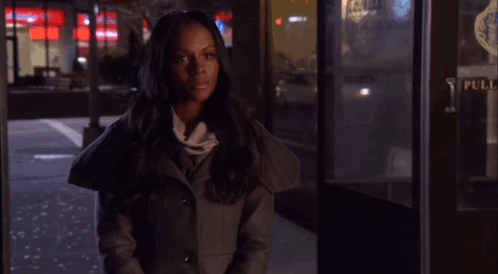 A Woman Stands In Front Of A Phone Booth That Has The Word Pull On It GIF