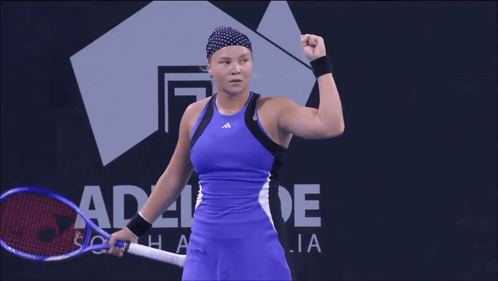A Woman Stands In Front Of A Sign That Says Adelaide On It GIF