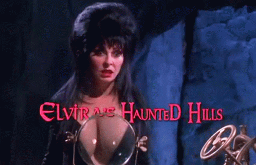 a woman stands in front of a sign that says elvira 's haunted hills on it