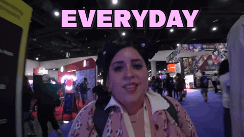 A Woman Stands In Front Of A Sign That Says Everyday On It GIF
