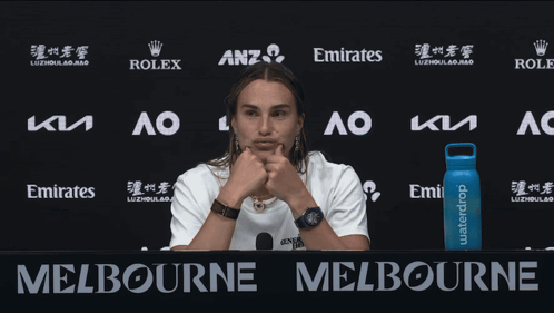 A Woman Stands In Front Of A Sign That Says Melbourne On It GIF