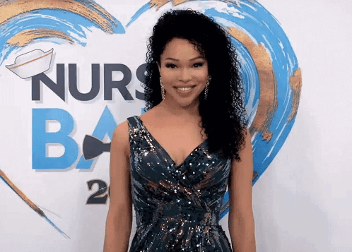 A Woman Stands In Front Of A Sign That Says Nurses Ba GIF