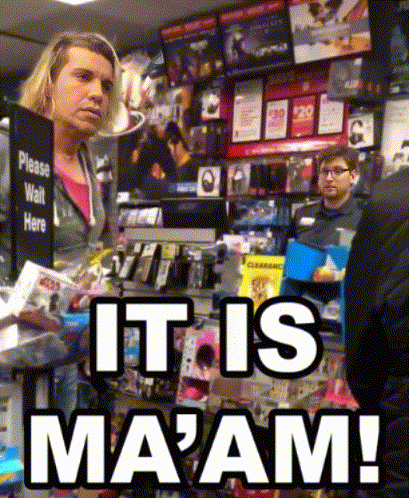 A Woman Stands In Front Of A Sign That Says " Please Wait Here " GIF
