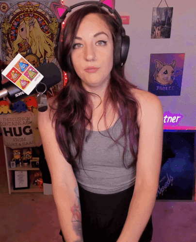A Woman Stands In Front Of A Sign That Says " This Cushion Contains A Hug " GIF