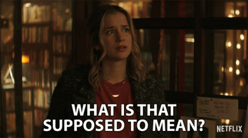 A Woman Stands In Front Of A Sign That Says What Is That Supposed To Mean Netflix GIF