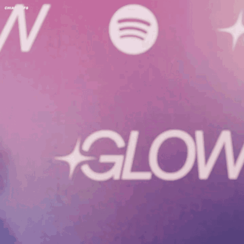 A Woman Stands In Front Of A Spotify Logo GIF