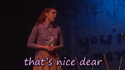 A Woman Stands In Front Of A Wall That Says ' That 'S Nice Dear ' GIF