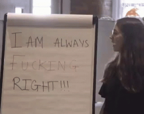 a woman stands in front of a white board that says i am always fucking right !!!