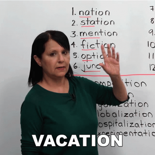 A Woman Stands In Front Of A White Board With The Word Vacation On It GIF