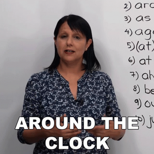 Woman Standing In Front Of Whiteboard With Around The Clock GIF