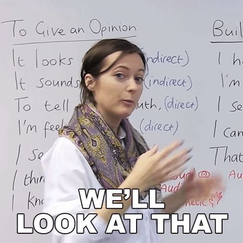 A Woman Stands In Front Of A White Board With The Words " We 'Ll Look At That " Written On It GIF