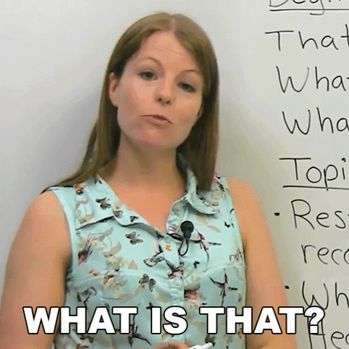 A Woman Stands In Front Of A White Board With The Words What Is That On It GIF