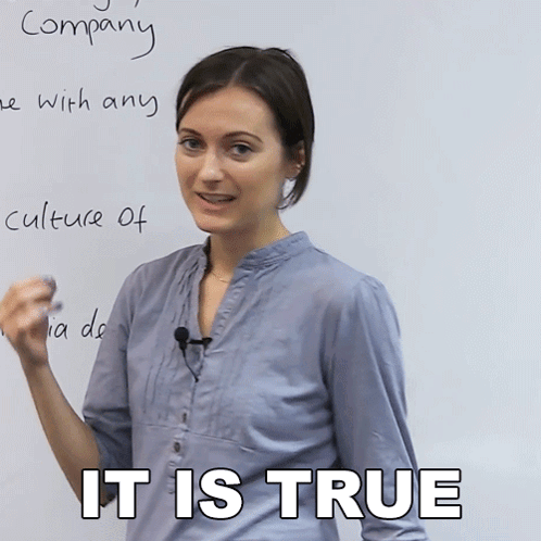 A Woman Stands In Front Of A Whiteboard With The Words " Company " Written In Cursive GIF