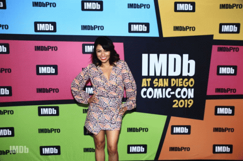 A Woman Stands In Front Of An Imdb At San Diego Comic Con 2019 Banner GIF