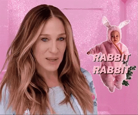 A Woman Stands Next To A Baby Dressed In A Rabbit Costume GIF