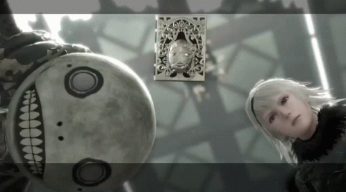 A Woman Stands Next To A Robot With A Picture Of A Woman On The Wall Behind Them GIF