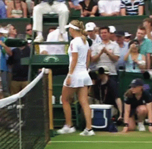 A Woman Stands On A Tennis Court In Front Of A Crowd And A Blue Cooler With The Letter B On It GIF