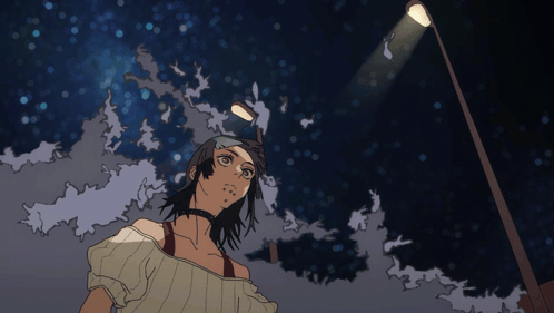 A Woman Stands Under A Street Light At Night GIF