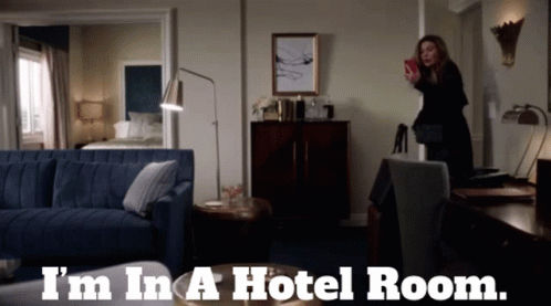 A Woman Taking A Picture In A Hotel Room With The Words I 'M In A Hotel Room GIF