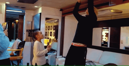 A Woman Taking A Picture Of A Man In A Van GIF
