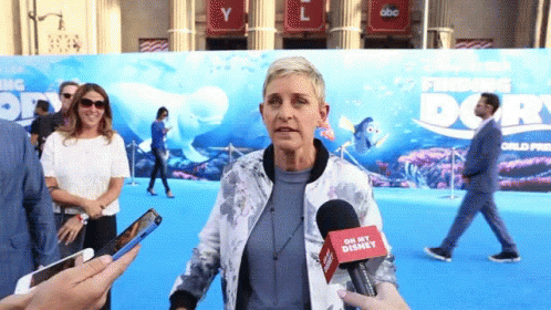 A Woman Talking Into A Microphone That Says Oh My Disney On It GIF