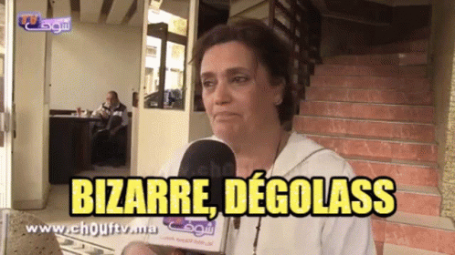 A Woman Talking Into A Microphone With The Words Bizarre Degolass Written Above Her GIF